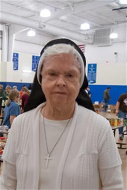 A photo of Sister Mary Robert Williams during a food collection in Sacred Heart's Boyd Gymnasium in 2013. 